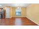 Dining area features laminate floors, a modern chandelier, and natural light at 2376 Bexley Dr, Tavares, FL 32778