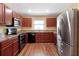 Spacious kitchen with stainless steel appliances and wood cabinets at 2376 Bexley Dr, Tavares, FL 32778