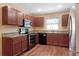 Well-lit kitchen features wooden cabinetry, granite counters, and stainless steel appliances at 2376 Bexley Dr, Tavares, FL 32778