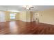Open-concept living room showcases laminate flooring, ceiling fan, and dining area at 2376 Bexley Dr, Tavares, FL 32778
