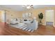 Cozy living room with hardwood floors, a ceiling fan, and comfortable white sofa at 2376 Bexley Dr, Tavares, FL 32778