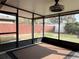 Enclosed patio with neutral colors, a ceiling fan, view of the backyard, and indoor-outdoor living at 2376 Bexley Dr, Tavares, FL 32778