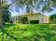 Expansive backyard with well-manicured lawn, mature trees, and a charming screened-in porch at 24104 Robinwood St, Leesburg, FL 34748