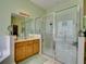 Modern bathroom with glass shower and wooden vanity at 24104 Robinwood St, Leesburg, FL 34748