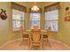 Cozy breakfast nook with a round table and four chairs at 24104 Robinwood St, Leesburg, FL 34748
