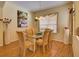 Dining area showcases wood floors, a glass table, and a decorative chandelier creating an inviting atmosphere at 24104 Robinwood St, Leesburg, FL 34748