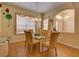 Bright dining room features a glass table with six chairs and natural light from the windows at 24104 Robinwood St, Leesburg, FL 34748