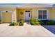 Charming front entrance featuring a white door, small garden, and partial garage view at 24104 Robinwood St, Leesburg, FL 34748