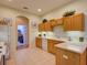 Well-lit kitchen with tile flooring and light wood cabinetry at 24104 Robinwood St, Leesburg, FL 34748