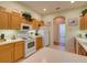 Bright kitchen equipped with white appliances and light wood cabinets at 24104 Robinwood St, Leesburg, FL 34748