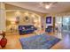 Bright living room featuring a blue sofa, glass coffee table, and access to the outdoor patio at 24104 Robinwood St, Leesburg, FL 34748