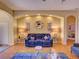 Inviting living room with wood floors, blue sofa, and decorative lighting at 24104 Robinwood St, Leesburg, FL 34748