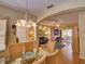 Open floor plan with a living room flowing into the dining area, featuring wood floors and archways at 24104 Robinwood St, Leesburg, FL 34748