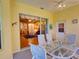 Enclosed patio area features a table with seating and a view into the living room with sliding glass doors at 24104 Robinwood St, Leesburg, FL 34748