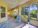 Bright sunroom with comfortable seating and large windows offering beautiful views of the landscaped yard at 24104 Robinwood St, Leesburg, FL 34748