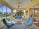 Inviting sunroom featuring comfortable seating and sliding glass doors to the backyard at 24104 Robinwood St, Leesburg, FL 34748