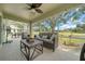 Screened-in lanai with wicker furniture and great views of the backyard at 2413 Tamarindo Dr, The Villages, FL 32162