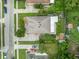 Aerial view of a home with a well-maintained lawn, mature trees, and inviting backyard deck at 257 Winding Cove Ave, Apopka, FL 32703