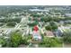 Aerial view of a neighborhood with mature trees surrounding a lake at 257 Winding Cove Ave, Apopka, FL 32703