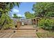 Charming backyard wooden deck and surrounding landscape, offering a peaceful retreat with a covered seating area at 257 Winding Cove Ave, Apopka, FL 32703