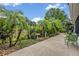 Backyard featuring lush tropical landscaping, a birdbath, and a green patio set at 257 Winding Cove Ave, Apopka, FL 32703