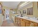 Bathroom featuring double sinks, a large mirror and a door to the backyard at 257 Winding Cove Ave, Apopka, FL 32703