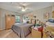 Bedroom with ceiling fan, window view, and a bed with a patterned comforter at 257 Winding Cove Ave, Apopka, FL 32703