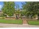 Well-manicured front yard with lush landscaping and a variety of trees and plants at 257 Winding Cove Ave, Apopka, FL 32703