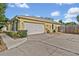 Side view of home with a two-car garage and driveway at 257 Winding Cove Ave, Apopka, FL 32703