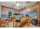 Spacious home office with vaulted ceiling, large desk, and a wall mural overlooking the ocean at 257 Winding Cove Ave, Apopka, FL 32703