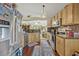Well-lit kitchen with stainless steel appliances, granite countertops, and wood flooring at 257 Winding Cove Ave, Apopka, FL 32703