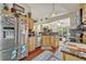 Well-lit kitchen with stainless steel appliances, granite countertops, and wood flooring at 257 Winding Cove Ave, Apopka, FL 32703