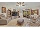 Comfortable living room features a ceiling fan and a large sliding glass door at 257 Winding Cove Ave, Apopka, FL 32703
