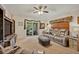 Relaxing living room boasts reclining sofa, ceiling fan, and sliding glass doors to outdoor patio at 257 Winding Cove Ave, Apopka, FL 32703