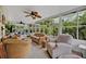 Sunroom featuring wicker furniture, ceiling fans, many windows, and views of the backyard at 257 Winding Cove Ave, Apopka, FL 32703
