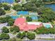 Community amenities view: clubhouse, swimming pool, tennis courts, offering recreational facilities surrounded by lush trees at 26800 Racquet Cir, Leesburg, FL 34748