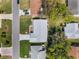 Aerial view of property boundaries showing the home's layout, landscaped yard, and proximity to neighboring houses at 26800 Racquet Cir, Leesburg, FL 34748