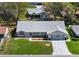 Aerial view of a lovely home with a well-maintained lawn and beautiful landscaping at 26800 Racquet Cir, Leesburg, FL 34748
