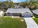 An aerial shot of a lovely single-story home, showcasing its landscaping and long driveway at 26800 Racquet Cir, Leesburg, FL 34748