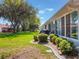 Beautiful backyard with a well-maintained lawn, landscaping, and a screened-in patio at 26800 Racquet Cir, Leesburg, FL 34748