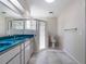 Bright bathroom featuring a clear glass shower, toilet, and double sink vanity at 26800 Racquet Cir, Leesburg, FL 34748
