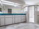 Bright bathroom featuring a clear glass shower and double sink vanity at 26800 Racquet Cir, Leesburg, FL 34748