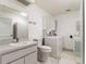 Bathroom with toilet, vanity, washing machine, and dryer at 26800 Racquet Cir, Leesburg, FL 34748