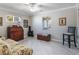 Bedroom featuring natural light, wood-look flooring, and vintage furniture at 26800 Racquet Cir, Leesburg, FL 34748