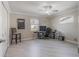 Bedroom featuring neutral walls, wood-look flooring, and a ceiling fan at 26800 Racquet Cir, Leesburg, FL 34748