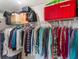 A well-organized walk-in closet with clothes and storage boxes at 26800 Racquet Cir, Leesburg, FL 34748