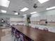 Bright craft room with ample counter space, storage cabinets, and a large table for creative projects at 26800 Racquet Cir, Leesburg, FL 34748