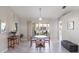 Dining room features neutral walls, modern floors, and sliding doors to a screened lanai at 26800 Racquet Cir, Leesburg, FL 34748