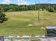 Aerial view of driving range with flags at different distances, providing golfers with a place to warm up and practice at 26800 Racquet Cir, Leesburg, FL 34748