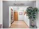 Bright gallery hallway featuring tile floors and art displays in a well-lit space at 26800 Racquet Cir, Leesburg, FL 34748